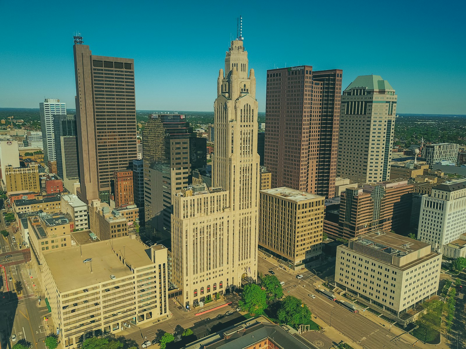 Aerial view of downtown Columbus, Ohio, showing the LeVeque Tower and surrounding office buildings on a clear day.